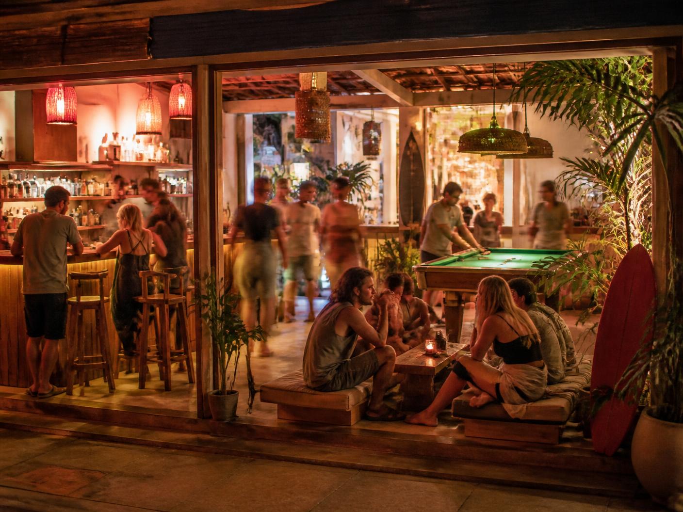 The social house at Pods House Samui at night — café bar and pool table
